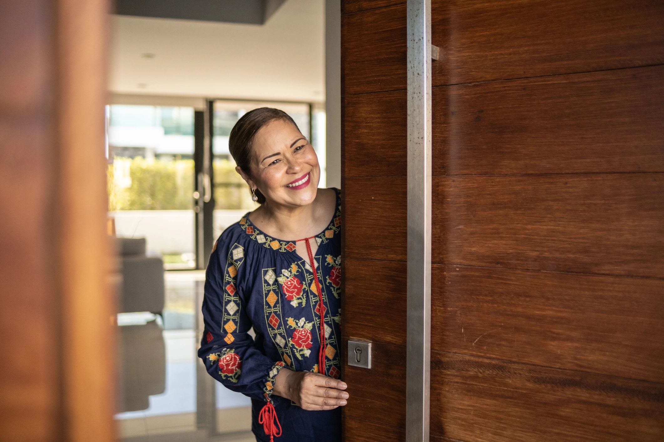 Homeowner opening the front door of a residence
